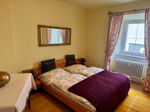 a bedroom with a bed and a mirror and a window at Haus Elfie in Haus im Ennstal