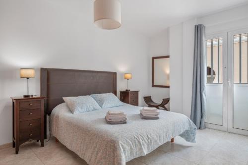 a bedroom with a large bed with towels on it at Suite Cava in Arrecife