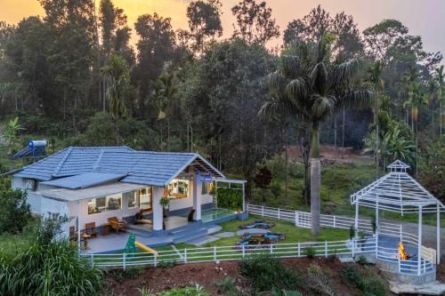 a house with a solar roof on top of it at StayVista at Kailaasa with Bonfire, Pool and Al-fresco in Suntikoppa
