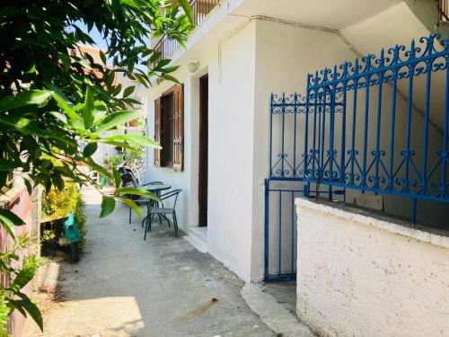a blue gate on the side of a building at Hera's Hideaway in Samos