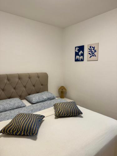 a bed with two pillows on it in a bedroom at Zio Nino in Sutomišćica