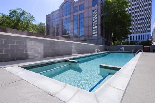 a swimming pool in the middle of a city at Home2 Suites by Hilton Greenville Downtown in Greenville