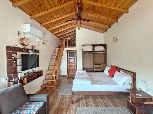 a living room with a white bed and a wooden ceiling at Woody Trails - Astronomy, Graphology, Family, Kainchi Dham in Bhowāli