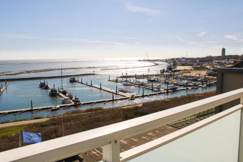 a view of a marina with boats in the water at WestCord Hotel Schylge in West-Terschelling