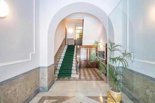 a stairway with green stairs in a building at RELSTAY - Assarotti Suites in Genoa