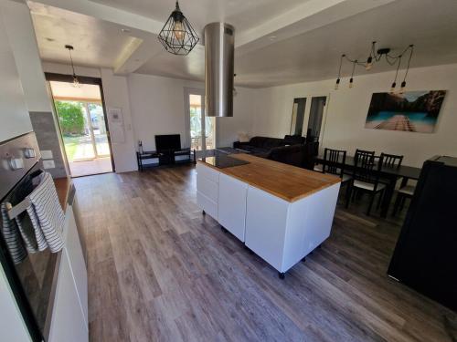 a living room with a kitchen and a dining room at Spacious and modern home 8 guests à Juvignac in Juvignac