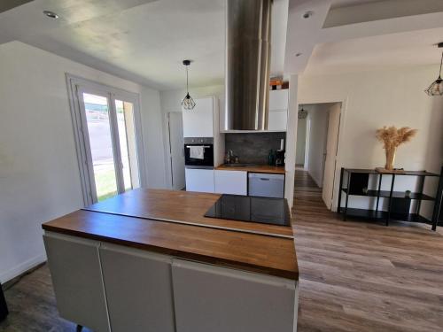a kitchen with a large island in a room at Spacious and modern home 8 guests à Juvignac in Juvignac
