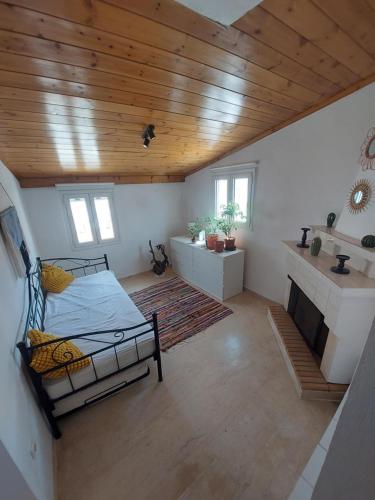 a bedroom with a bed and a wooden ceiling at Marialena's houses in Methoni
