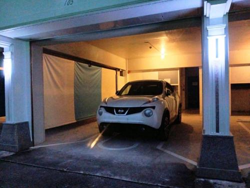 a car parked in a parking lot at night at Hotel PUTIT BELLプチベル-1台駐車無料イオンモール沖縄ライカムまで車で6分 in Okinawa City