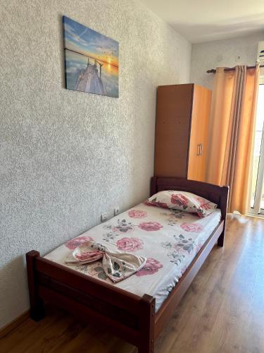 a bedroom with a bed with a picture on the wall at Cache Apartments in Ulcinj