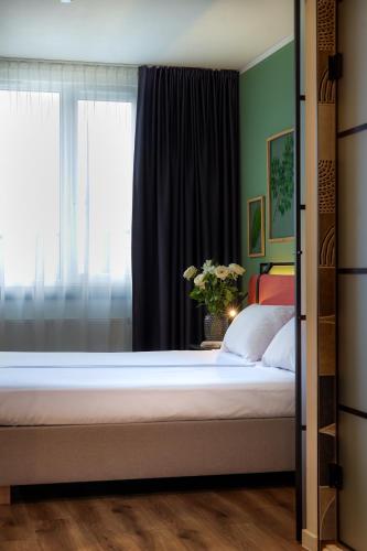 a bedroom with a large bed with a window at Hotel Convictus Cracovia for business & travellers in Kraków