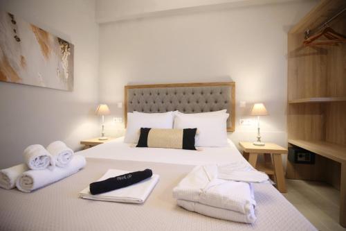 a bedroom with a bed with towels on it at ILIOS apartment in Nydri