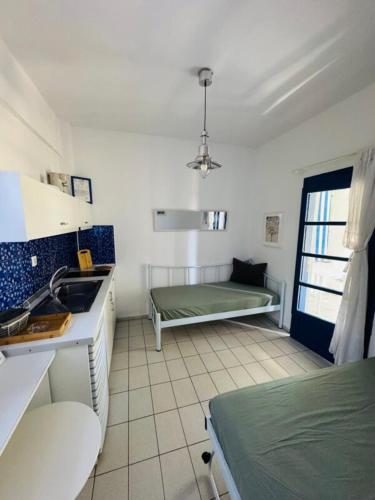 a kitchen with a sink and a bed in a room at Mikri elia beach in Lagomandra