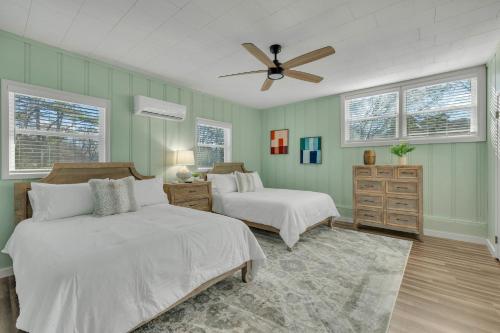 a bedroom with two beds and a ceiling fan at Newly Remodeled Home Minutes from MTSU Short drive to downtown Nashville in Murfreesboro