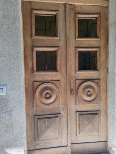 a wooden door with two windows on a building at La Casina in Amelia