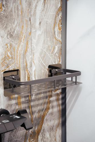 a shelf in a room with a marble wall at Хостел 1377 in Astana