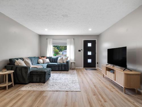 a living room with a couch and a flat screen tv at 291 Hunter Ave bungalow 