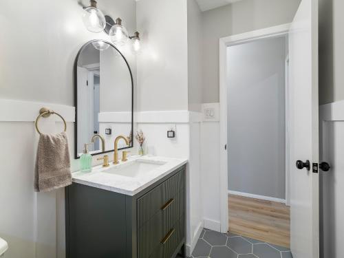 a bathroom with a sink and a mirror at 291 Hunter Ave bungalow 