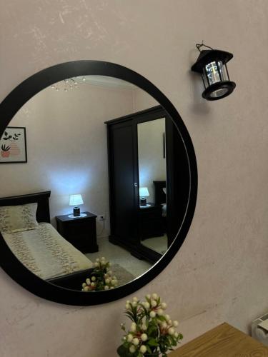 a mirror on the wall of a bedroom with a bed at The best place with best view in Ariana