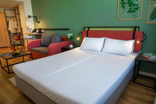 a bedroom with a large bed and a living room at Hotel Convictus Cracovia for business & travellers in Kraków