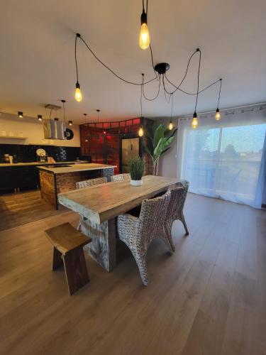 une salle à manger avec une grande table et des chaises en bois dans l'établissement 8-person apartment - Chill & beach 5 min away, à Saint-Laurent-de-la-Salanque