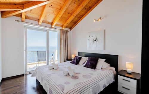 a bedroom with a bed with a view of the ocean at Villa Antonia by Villas Guide in Blato