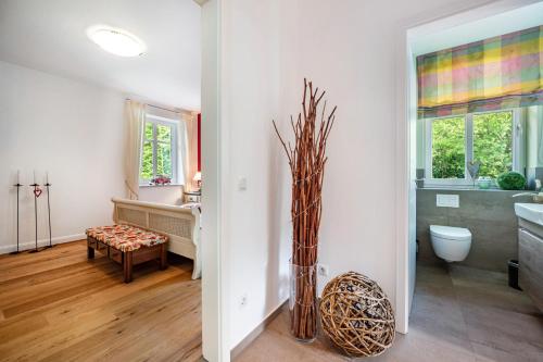 a bathroom with a sink and a toilet in a room at Ferienwohnung am Kronsberg in Bösel