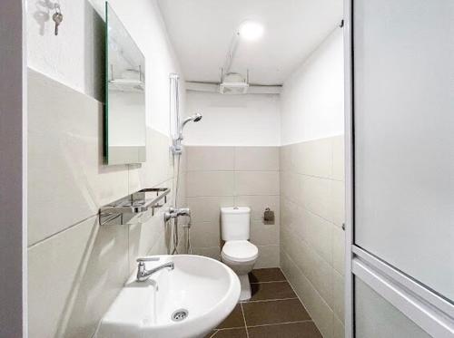 a small bathroom with a toilet and a sink at Pearl Cottage - 2min Drive to Lam Wah Ee Hospital in George Town