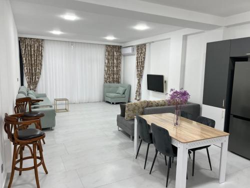 a living room with a couch and a table at Style Home Buzovna in Baku