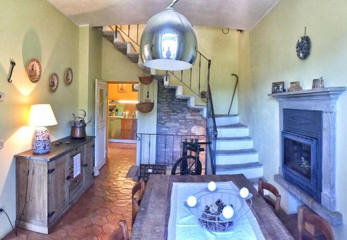 a dining room with a table and a fireplace at Villa Le Giare in Vignone