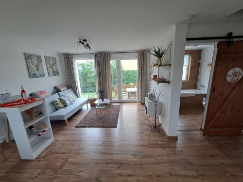 a living room with a couch and a table at Remete Vendégház in Szekszárd