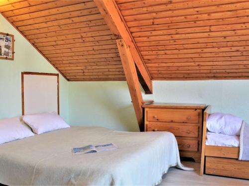 a bedroom with two beds and a wooden ceiling at Appartement 2 pièces, 4 couchages à Risoul 1850 - FR-1-330-39 in Risoul