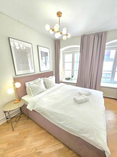 a bedroom with a large bed with white sheets at Stylish Riga Old Town getaway in Riga