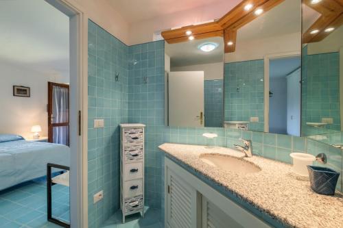 a bathroom with a sink and a mirror at Villa Ikigai, luxury, sea view swimming pool in Porto Rafael