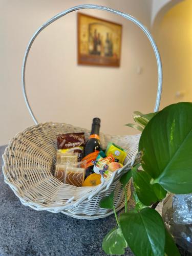 a basket filled with food and beer on a table at Seafront Maisonette Ocean Views & Terrace in Mellieħa