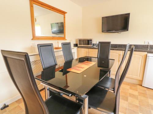 a dining room with a black table and chairs at 3 Warke Place in Coleraine