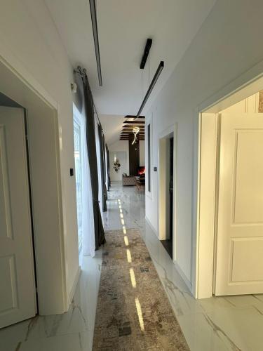 a hallway with white doors and a tile floor at Amal Residence in Sarajevo