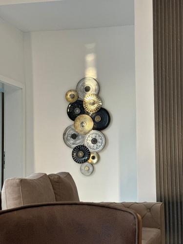 a wall with a bunch of plates on a wall at Amal Residence in Sarajevo