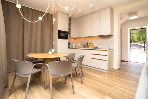 a kitchen and dining room with a table and chairs at VSG Resort - Apartments 200m from Beach, Pool, Sauna & Jacuzzi in Klimno