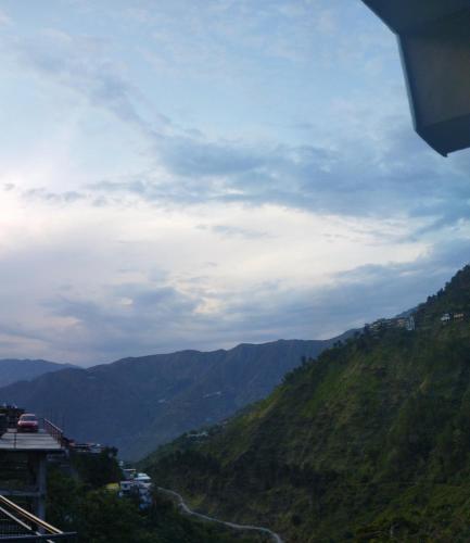 a view of a mountain with a road on it at Sheetal Restaurant in Mussoorie