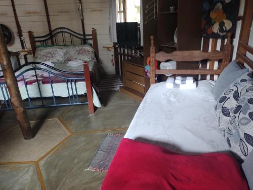Postel nebo postele na pokoji v ubytování CHALE e SUÍTE com Mimos Café Manhã