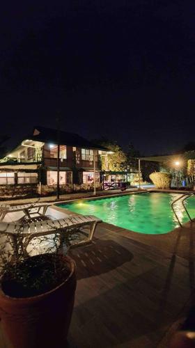 a large swimming pool at night with lights at Estancia Primavera in Angeles City in Mining