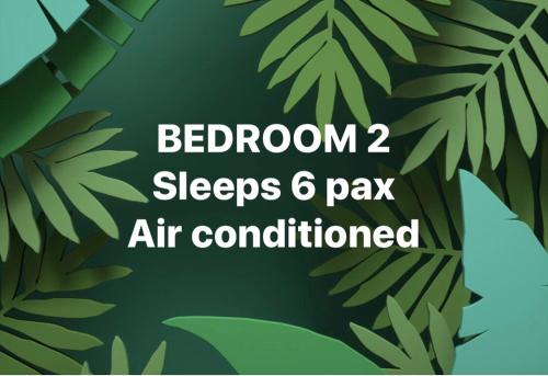 a green leafy background with the words bedroom sleeps pay air conditioned at Estancia Primavera in Angeles City in Mining