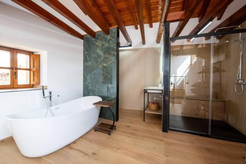 a bathroom with a large tub and a glass shower at Miravilla 25 Potes 4 in Potes