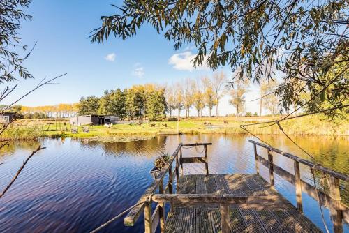 a wooden bench sitting in the middle of a lake at Nature lovers Amsterdam Zaandam in Wijdewormer