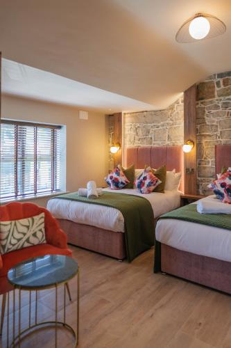 a hotel room with two beds and a couch at The Woodquay Townhouse in Galway