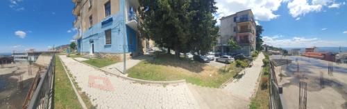 a building with a fence next to a street at The Cozy Home in Krujë