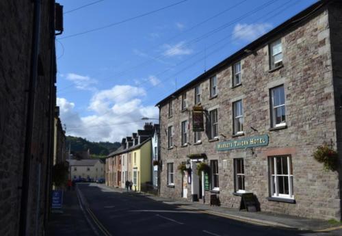 an old brick building on the side of a street at Bear cottage in Brecon