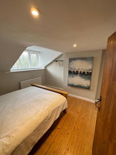 a bedroom with a bed and a painting on the wall at Bear cottage in Brecon