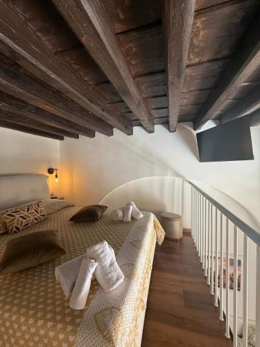 a bedroom with a large bed with towels on it at La Maison di Annamaria in Bari